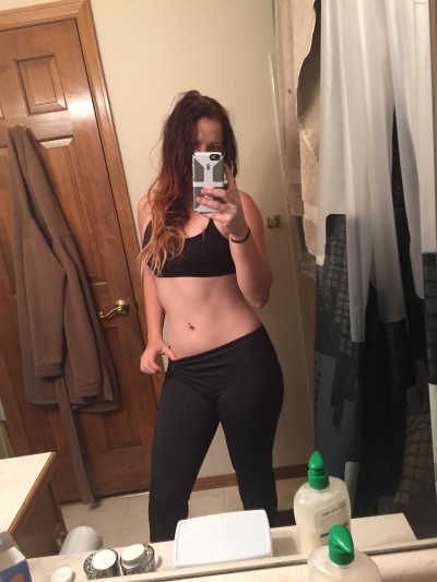 Undresses in front of the mirror