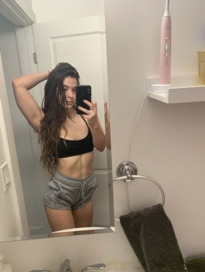 Young brunette takes pictures of herself on her smartphone exposing her holes and nice figure