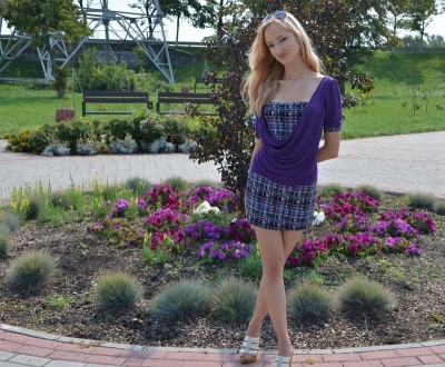 Long-legged woman posing on the street